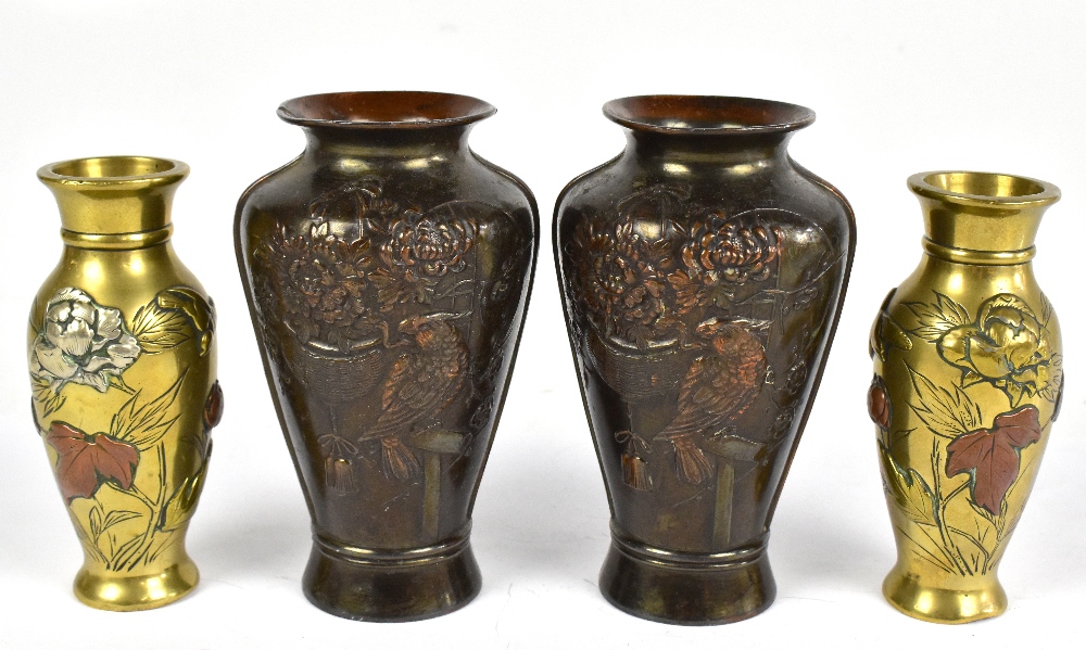 A pair of Japanese polished bronze vases, decorated with flowers and a bird, height 12.5cm, with a