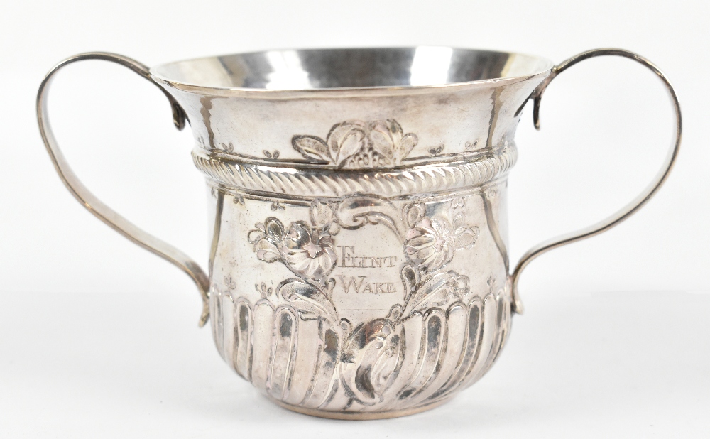 A George III hallmarked silver porringer, with part embossed decoration and inscribed 'Flint