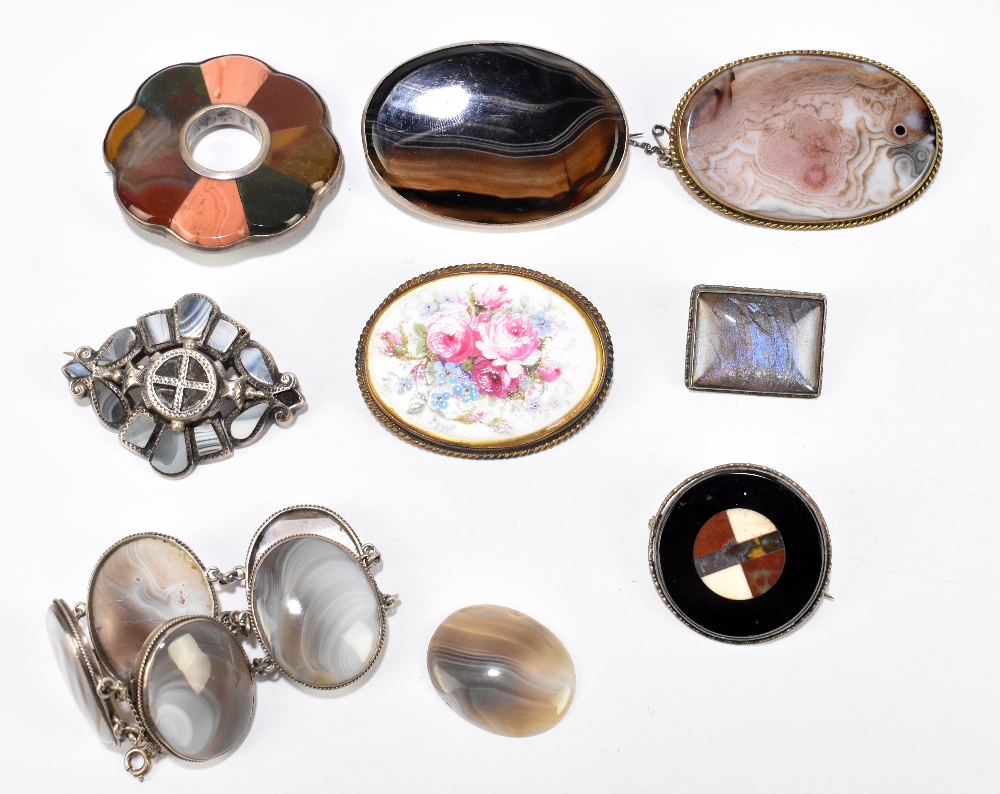 A collection of brooches including two large oval polished agate examples, two Scottish white