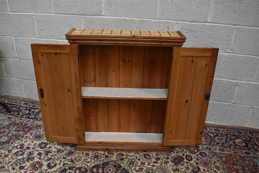 A pine two door cupboard, with tiled top enclosing one fixed shelf, height 89cm, width 69.5cm, depth - Image 3 of 3