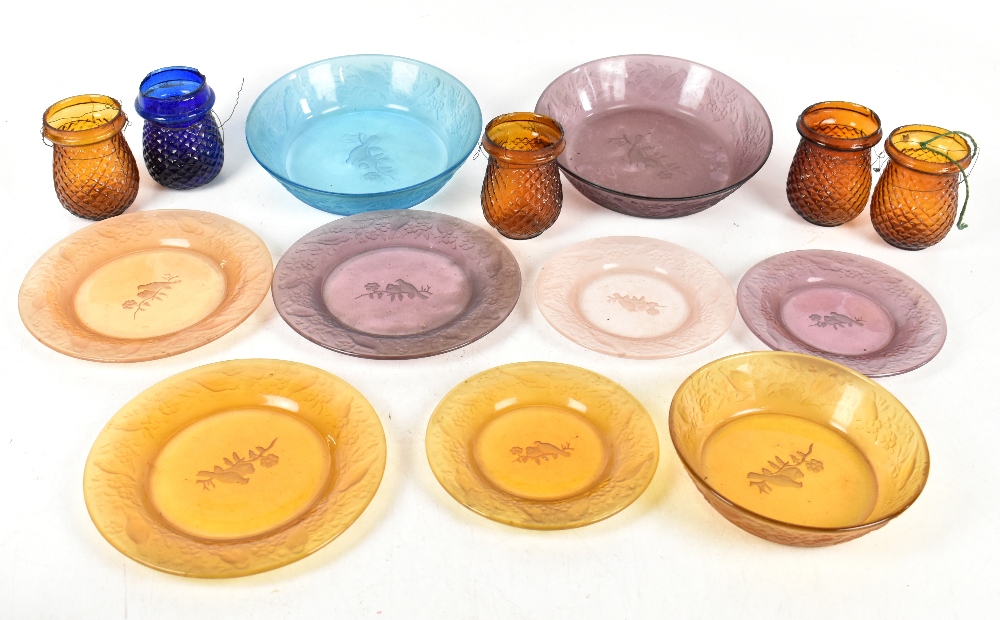 A mixed lot of coloured glass plates, together with tealight holders.