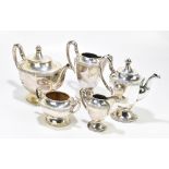 An unmarked white metal five piece tea service with panelled bodies and cast rims, with ivory