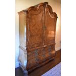 A monumental late 18th century Dutch figured and burr walnut veneered linen press, the arched
