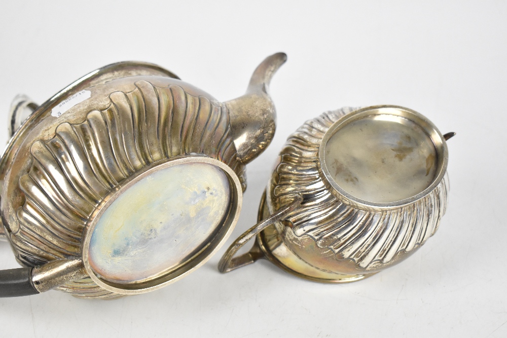 DANIEL & JOHN WELBY; a late Victorian hallmarked silver three piece part gadrooned tea set, length - Image 3 of 4