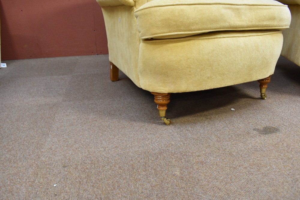 A pair of good quality yellow upholstered armchairs on turned supports with brass castors. - Image 2 of 4