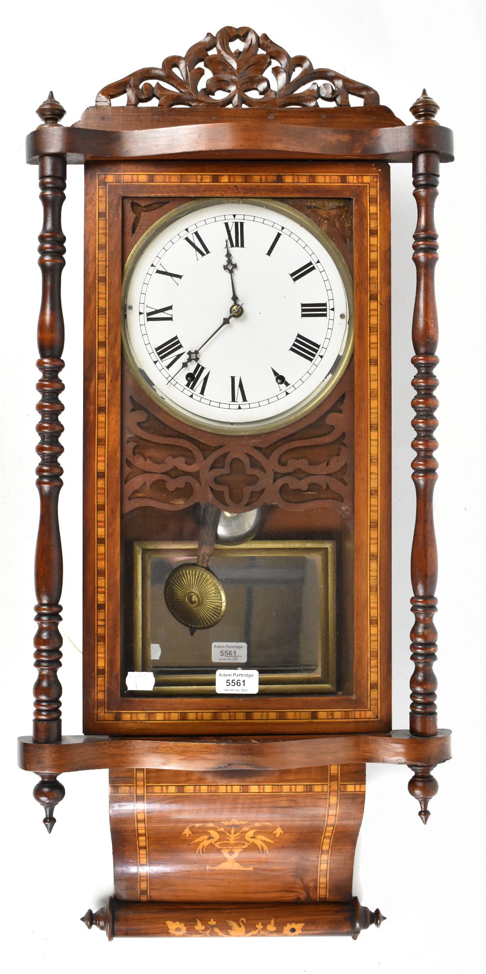 A 19th century American inlaid walnut wall clock with carved pediment above the circular dial set