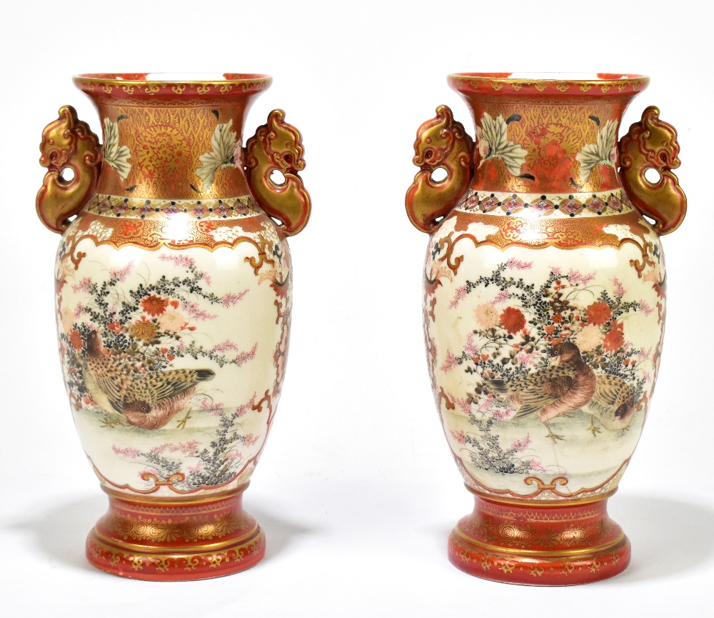 A pair of early 20th century Japanese Kutani twin handled vases painted with figures in landscape