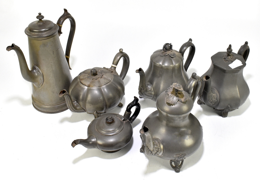 A group of six 19th century Britannia metal teapots, height of largest 28cm.