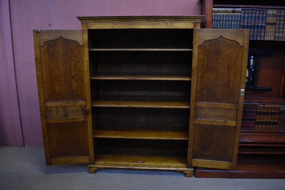 A good quality reproduction oak cupboard, probably by Titchmarsh & Goodwin, with pair of panel doors - Image 3 of 3