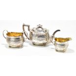 GEORGE FENWICK; a George III hallmarked silver three piece tea service with chased floral decoration