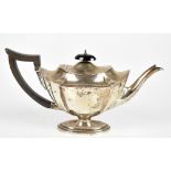 THOMAS BRADBURY & SONS; an Edwardian hallmarked silver teapot, with wooden handle and oval foot,