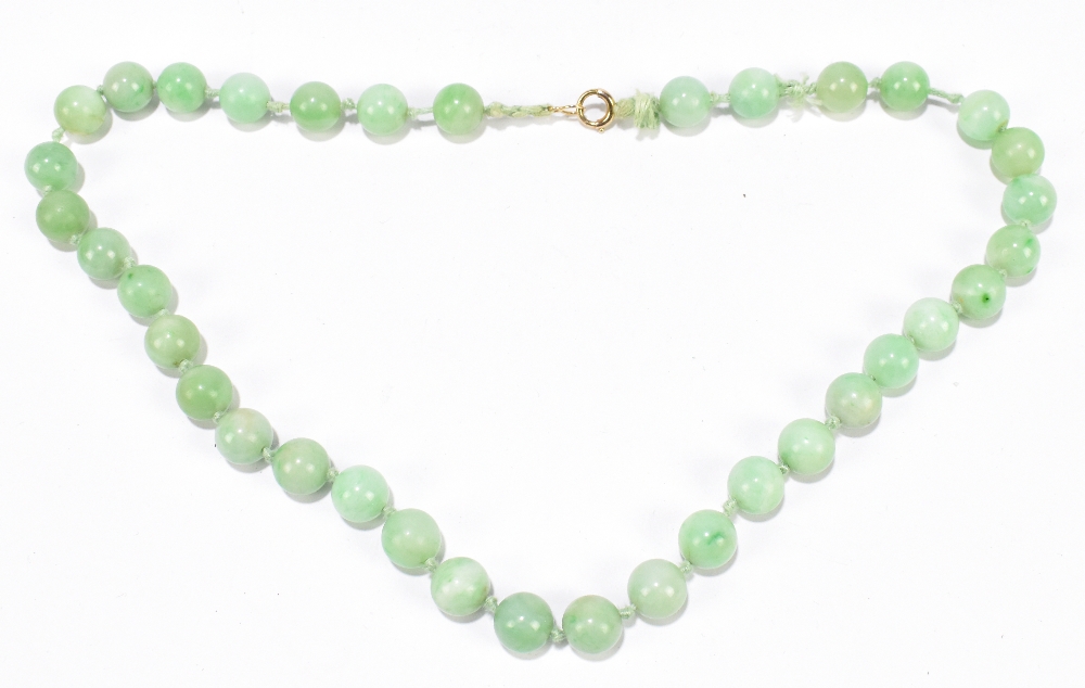 A 1920s/30s jade bead necklace, re-strung and with modern ring loop fastener, length 46cm, each bead