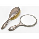 A George V hallmarked silver mounted dressing table mirror and a similar brush, the mirror