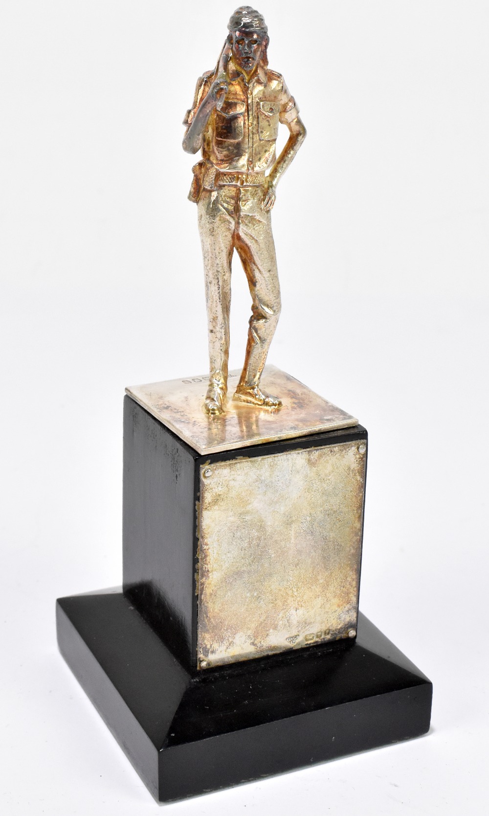 GARRARD & CO; a hallmarked silver figure of an Oman soldier, on ebonised plinth, London 1983, weight