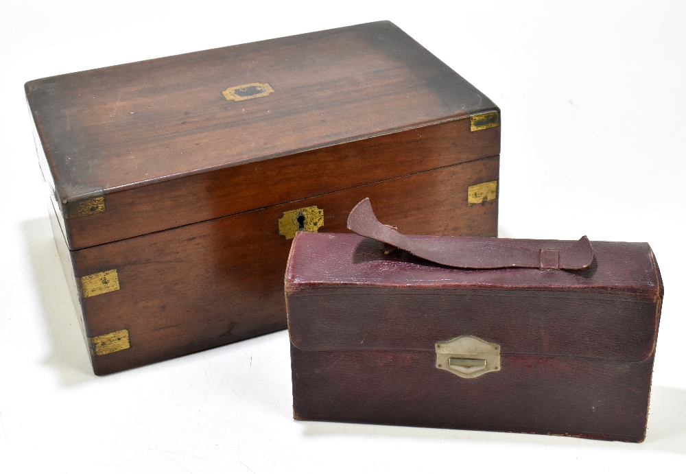 A Victorian brass bound walnut writing slope, width 35cm, and a travelling vanity set.