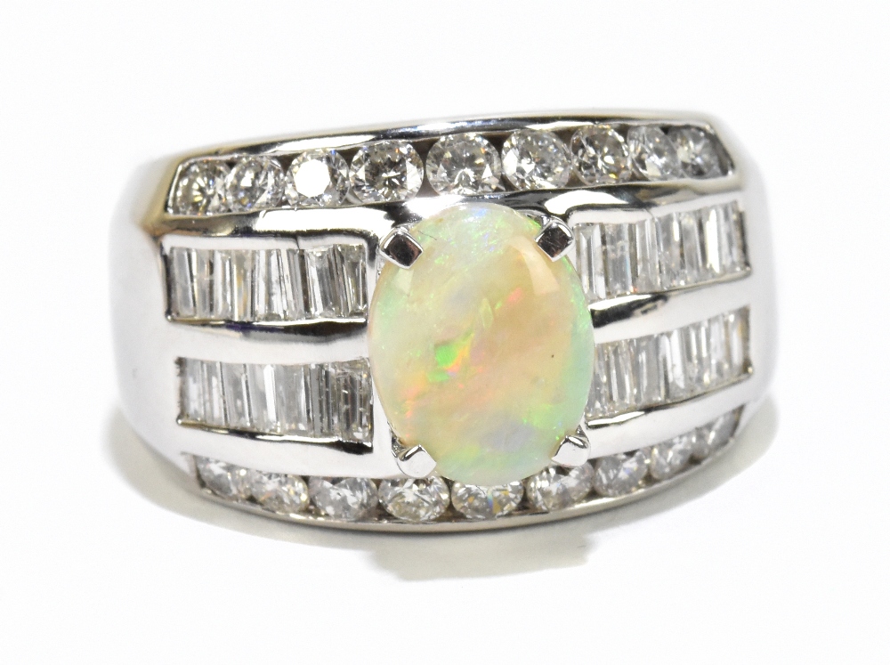 A white metal broad diamond and opal ring, the central oval opal in four claw setting, within a