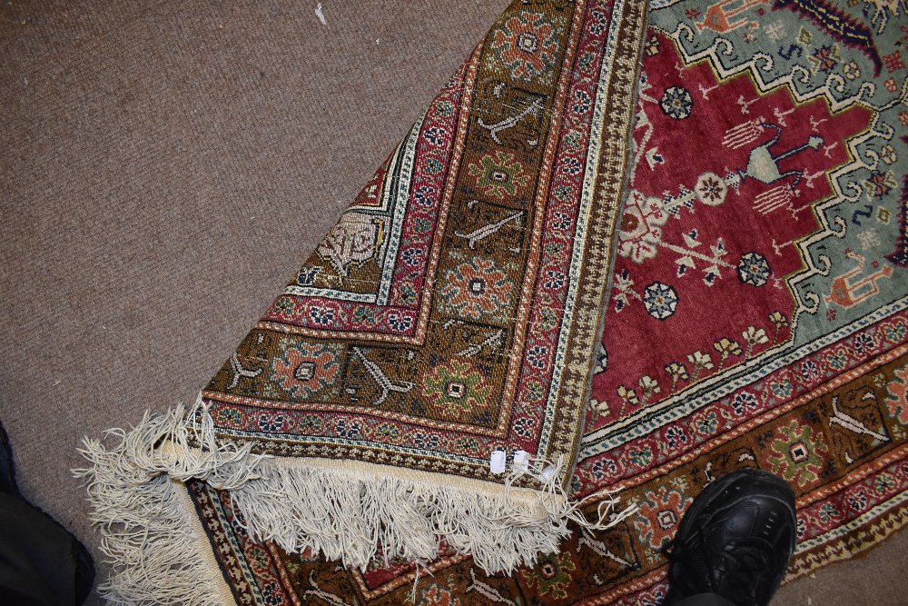 A Caucasian hand woven prayer rug, worked with all-over geometric motifs against a red ground, 140 x - Image 2 of 2