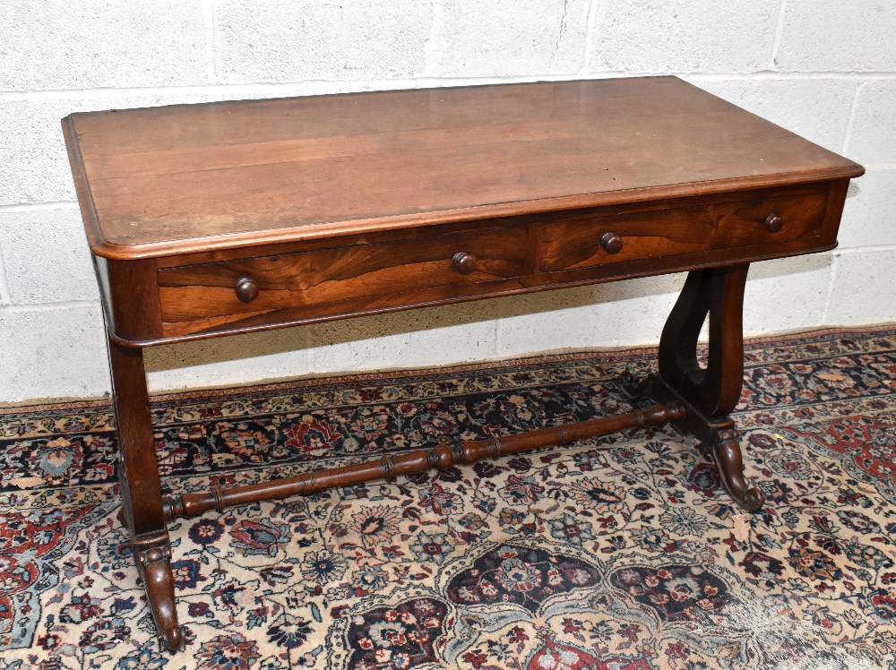 A 19th century rosewood library table, the rounded rectangular top above two frieze drawers, on lyre