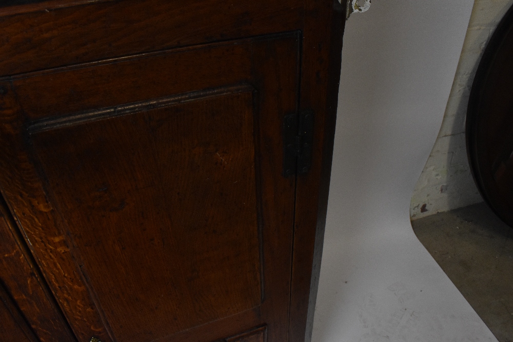 An 18th century oak hanging corner cupboard with iron H-hinges and a pair of panelled doors, width - Image 2 of 3