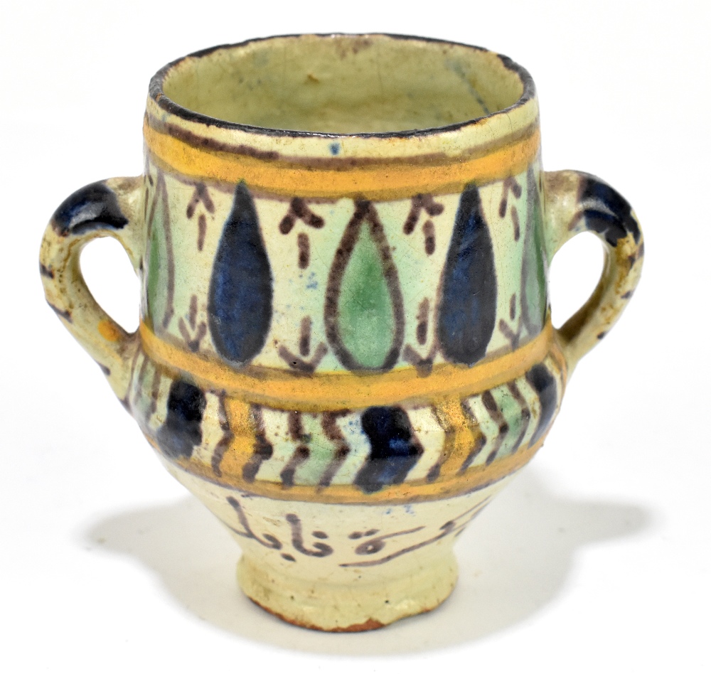 A 19th century Persian pot, height 9cm.