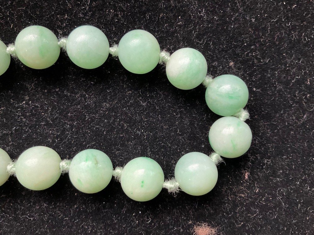 A 1920s/30s jade bead necklace, re-strung and with modern ring loop fastener, length 46cm, each bead - Image 6 of 8