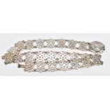 A Chinese pierced white metal belt, possibly a nurse's belt, with engraved floral detailing, 4ozt/