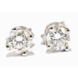 A pair of 9ct white gold diamond ear studs, the twin brilliant cut stones, four claw set,