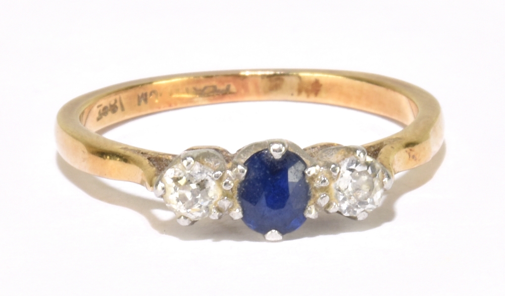 An 18ct yellow gold sapphire and diamond three stone ring with claws set in platinum, size K,