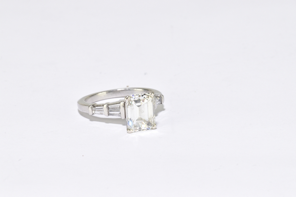 A platinum and diamond solitaire ring, the principal emerald step cut stone, weighing 3.04cts, - Image 2 of 4