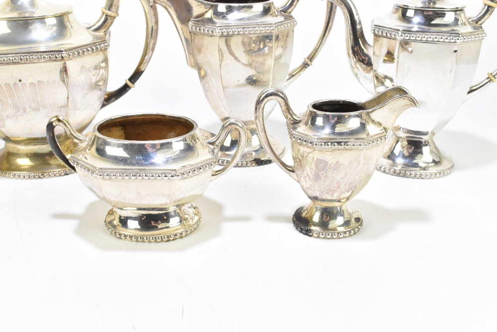 An unmarked white metal five piece tea service with panelled bodies and cast rims, with ivory - Image 3 of 3