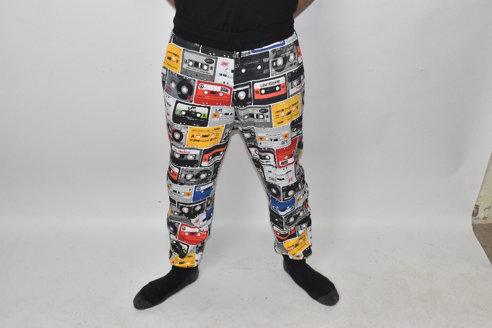 LOVE MOSCHINO; a pair of multi-coloured 100% cotton 'Cassette Tape' print jogging bottoms with two - Image 2 of 5