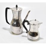 A 20th century hammered white metal coffee pot and cover with ebonised finial and handle, height