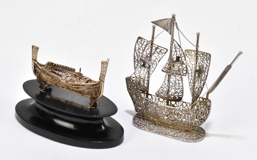 Two Eastern white metal filigree models of boats including a four masted example, height 9.5cm, (