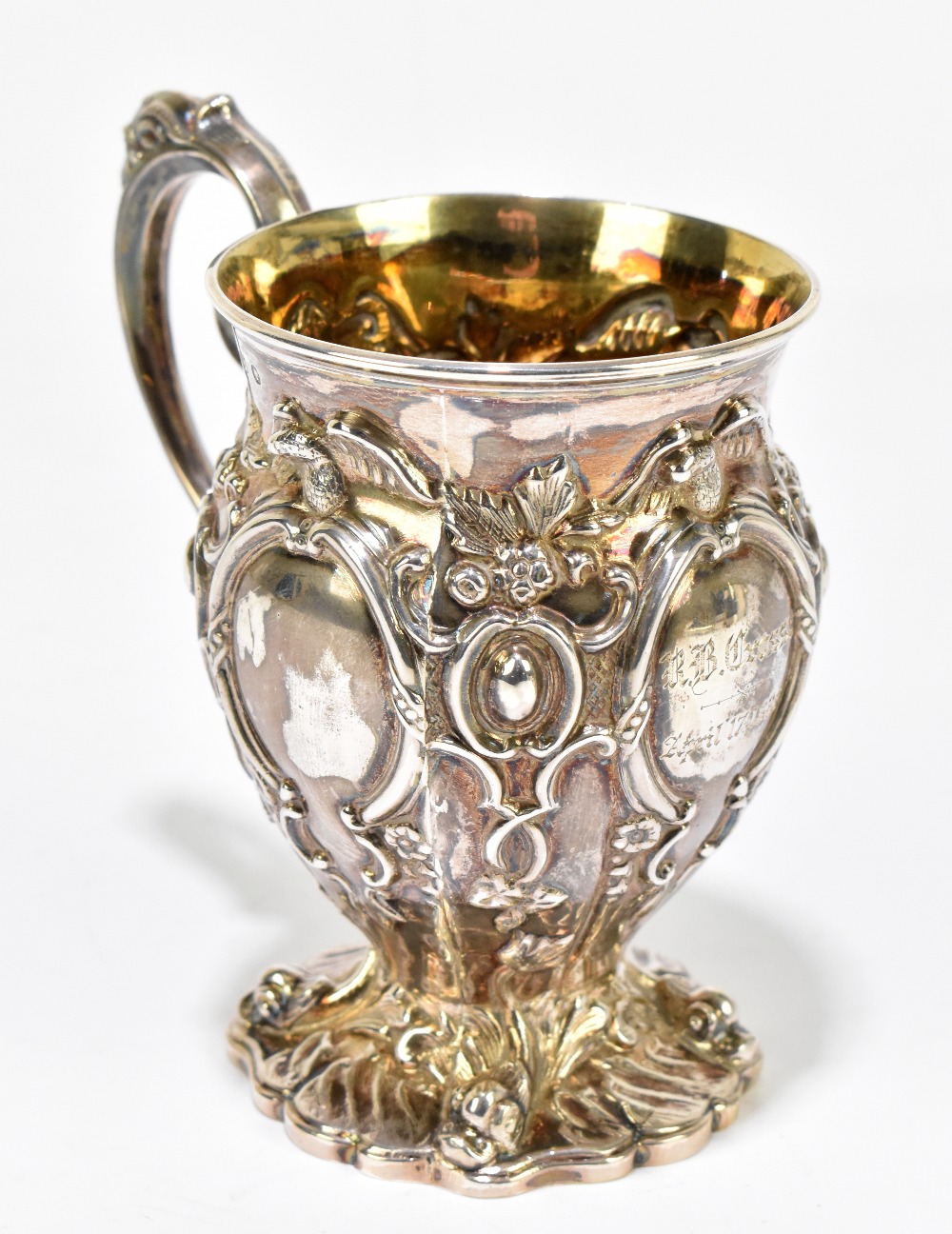 HAWKESWORTH, EYRE & CO; a Victorian hallmarked silver christening mug elaborately cast with birds