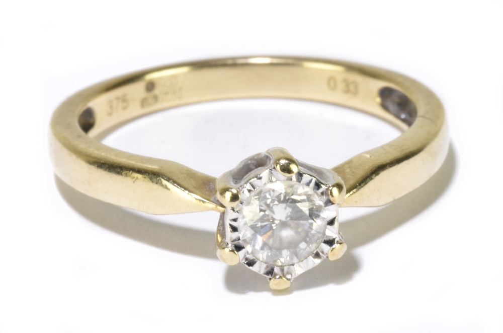 A contemporary 9ct yellow gold diamond solitaire ring, the single round brilliant cut stone weighing