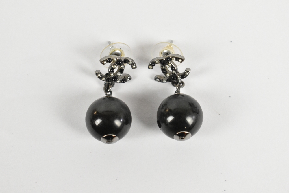 CHANEL; a pair of authentic 'CC' pierced earrings set in Ruthenium metal, stamped 'Chanel' to - Image 2 of 2