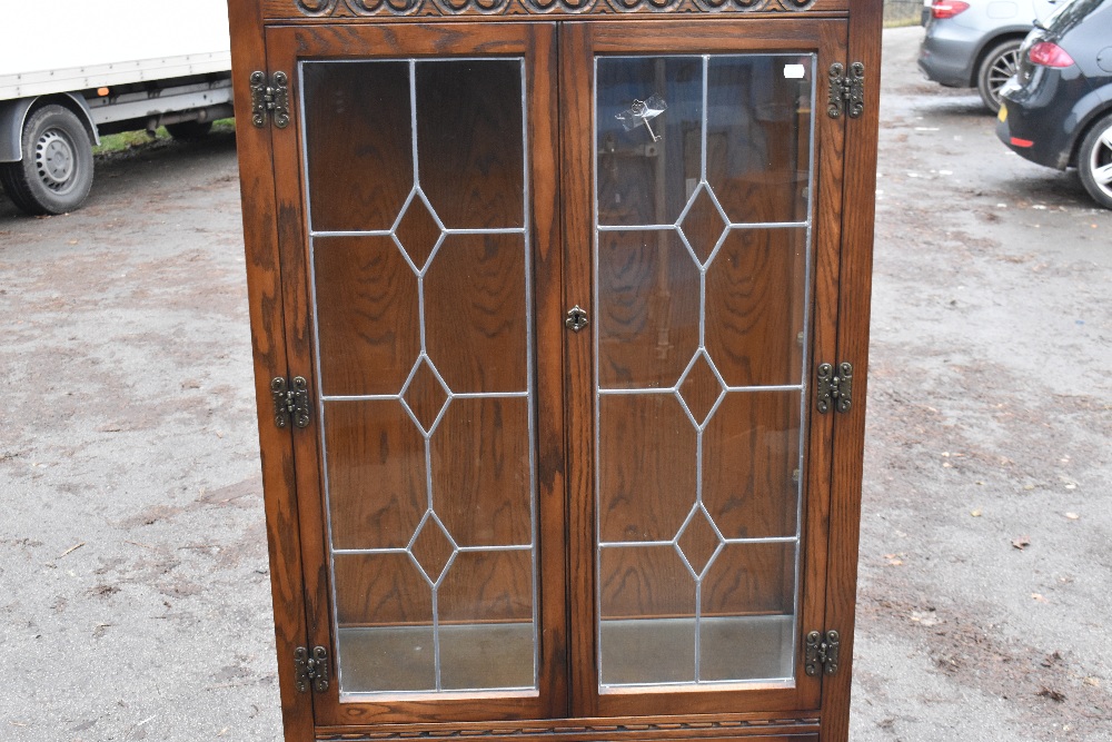 A modern Priory style oak display cabinet with carved detail and a pair of leaded glazed doors, - Image 3 of 5