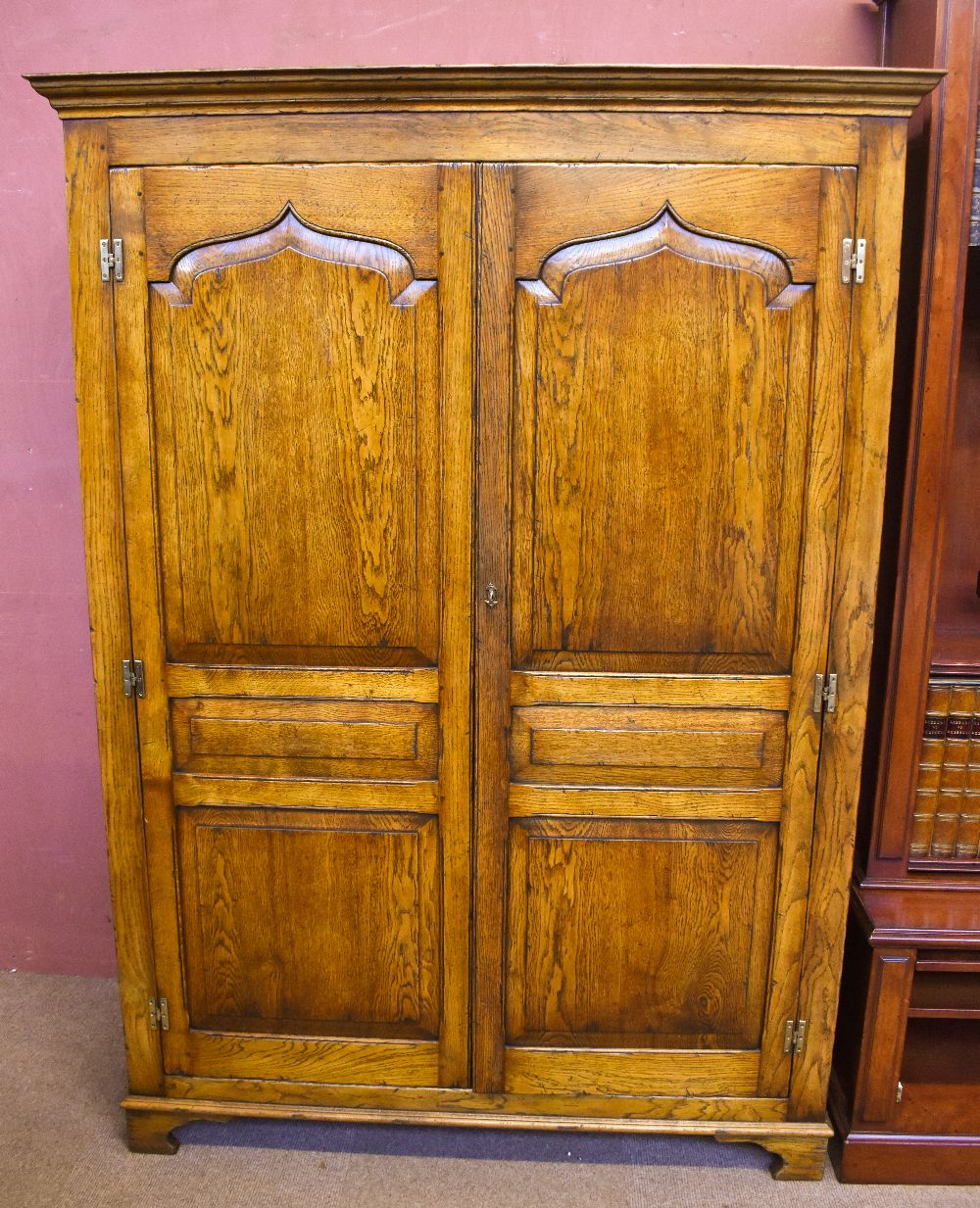 A good quality reproduction oak cupboard, probably by Titchmarsh & Goodwin, with pair of panel doors