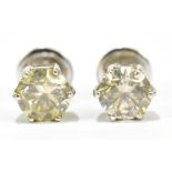 A pair of a diamond and white metal ear studs, the diamond size approx. 0.5, unmarked.