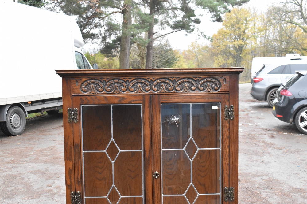 A modern Priory style oak display cabinet with carved detail and a pair of leaded glazed doors, - Image 4 of 5