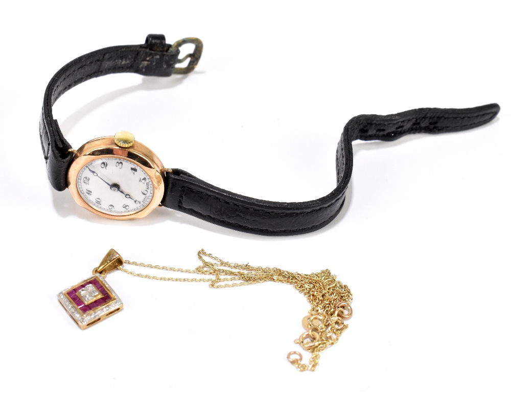 A lady's vintage 9ct yellow gold wristwatch, and a 9ct yellow gold fine link chain suspending a ruby
