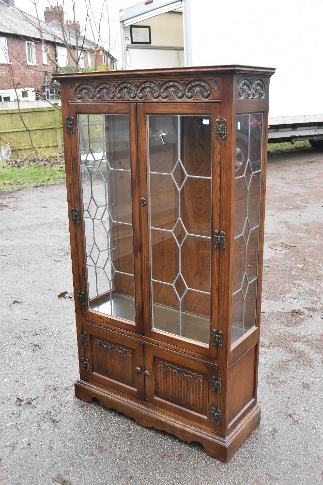 A modern Priory style oak display cabinet with carved detail and a pair of leaded glazed doors, - Image 5 of 5