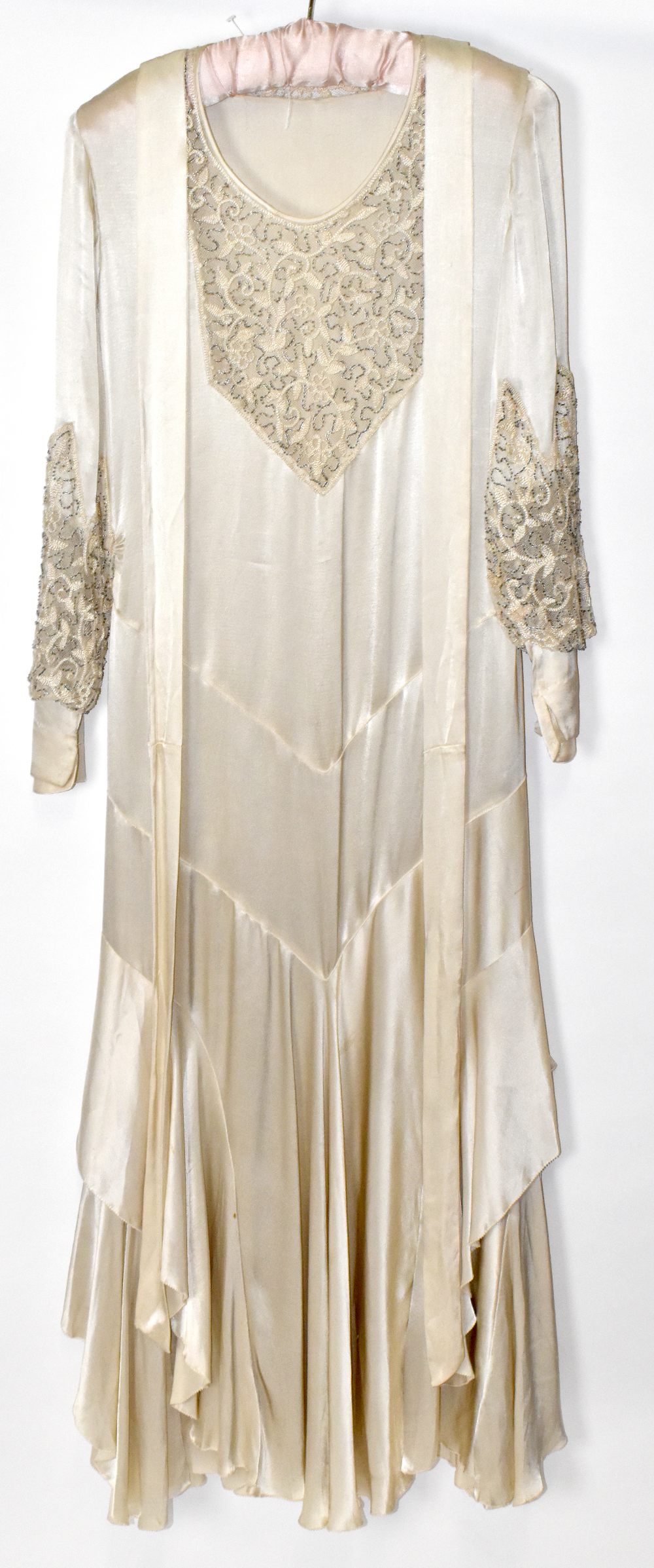 A 1920s handmade cream silk and lace beaded wedding dress decorated with sequins and beads,