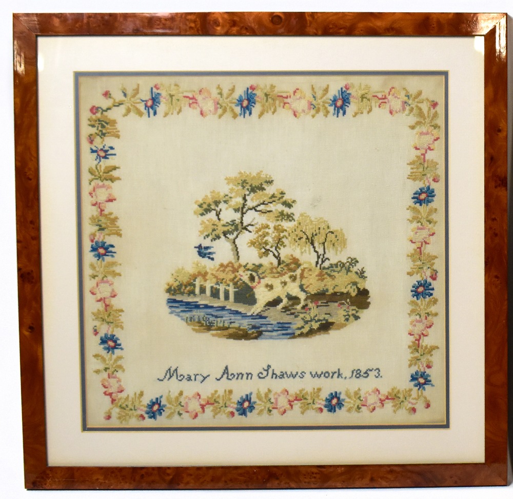 A 19th century needlework sampler decorated with a dog and bird in landscape by Mary Ann Shaw, dated