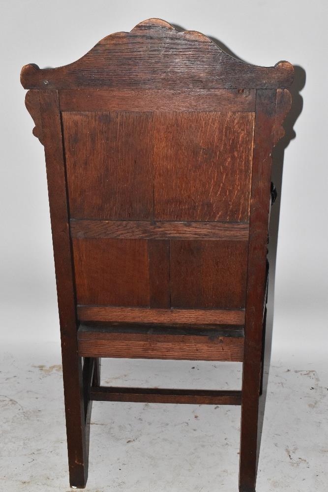 A Victorian carved oak open arm elbow chair with iron mask terminals and square supports. - Image 2 of 4