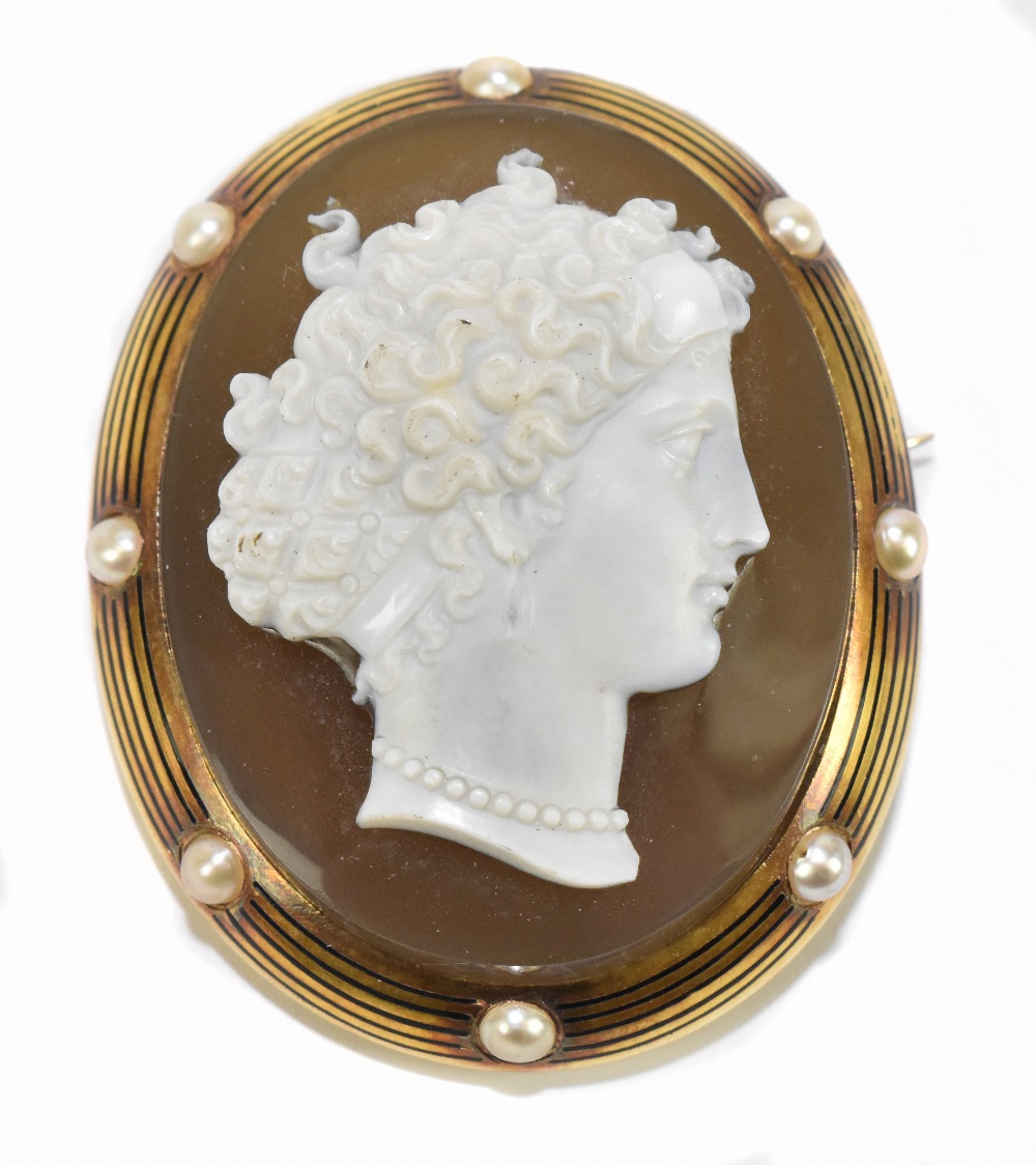A Victorian yellow metal oval cameo brooch, decorated with the portrait of a maiden with curly
