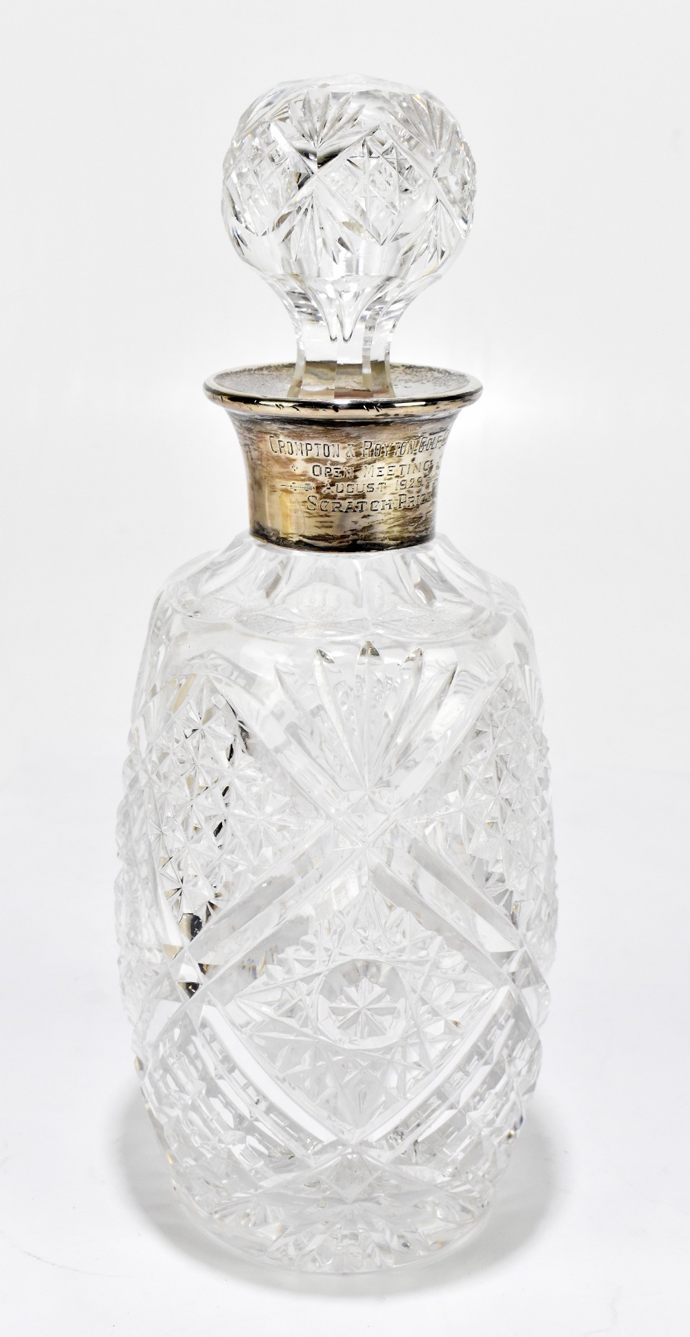 A George V hallmarked silver mounted cut glass decanter and stopper, with Compton & Royton Golf Club