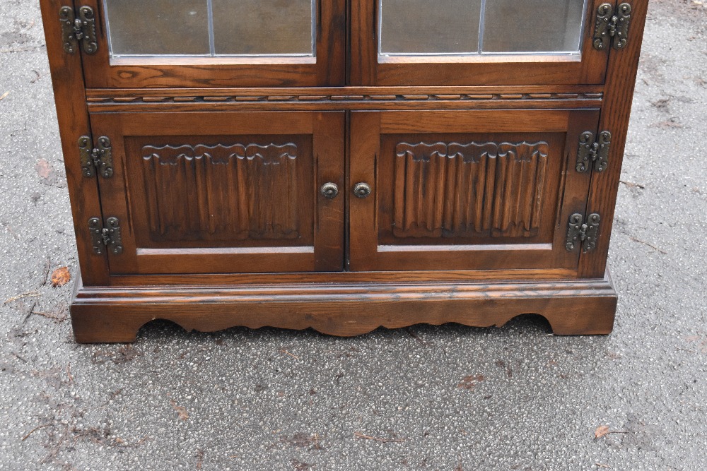 A modern Priory style oak display cabinet with carved detail and a pair of leaded glazed doors, - Image 2 of 5