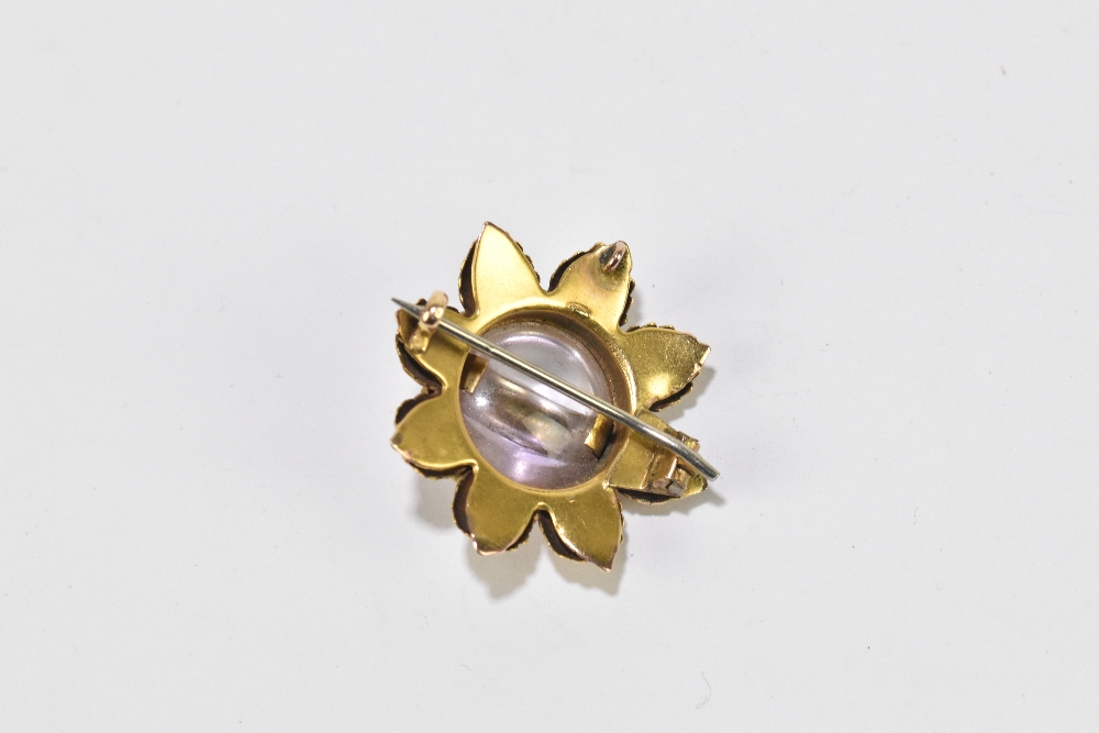 A yellow metal and pale amethyst flowerhead brooch formed of eight textured leaves and centred - Image 2 of 2