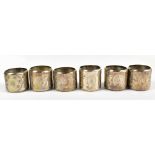 A cased set of six circa 1900 white metal napkin rings, engraved with various birds and butterflies,